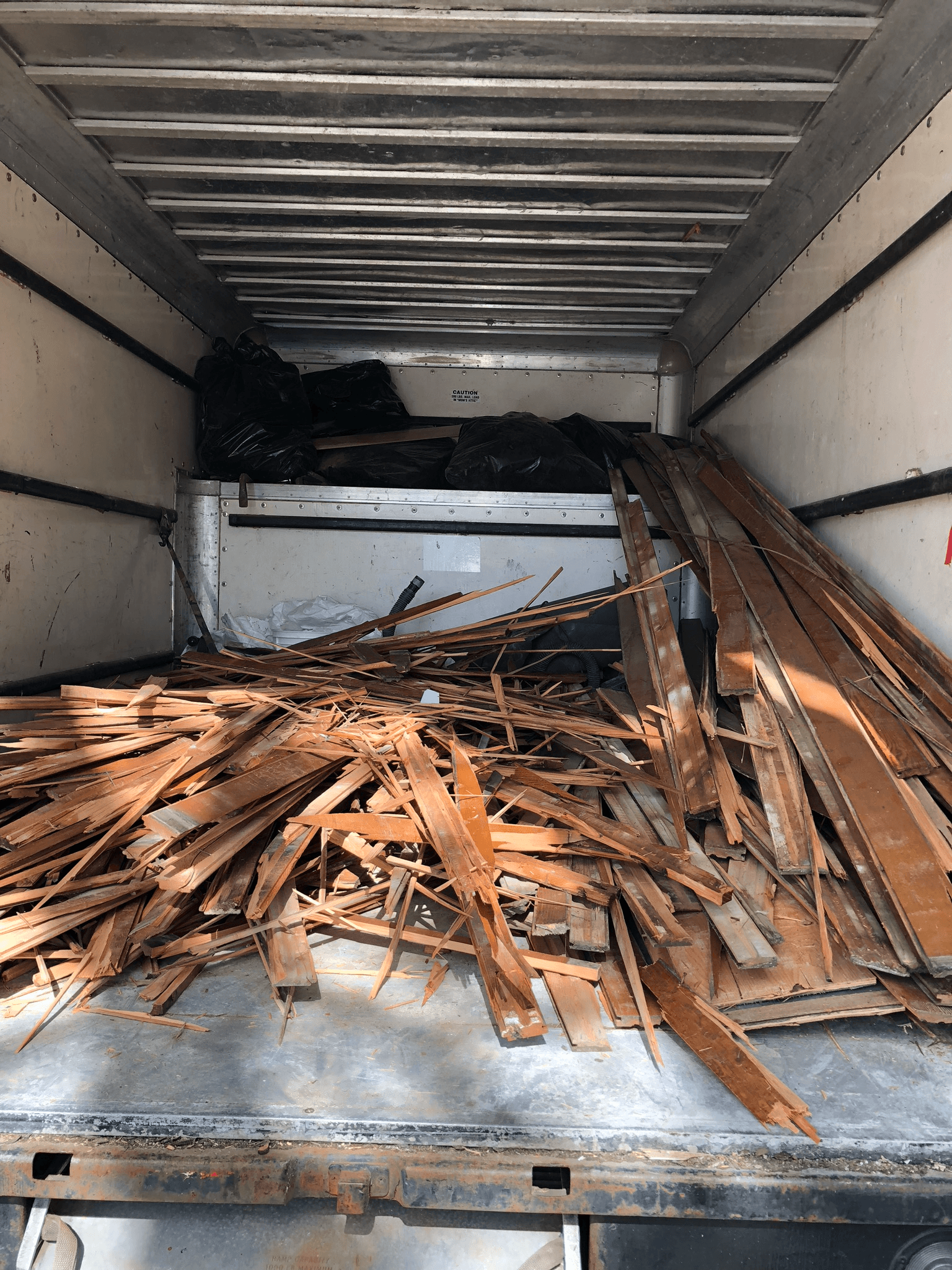 Removed hardwood flooring loaded for disposal