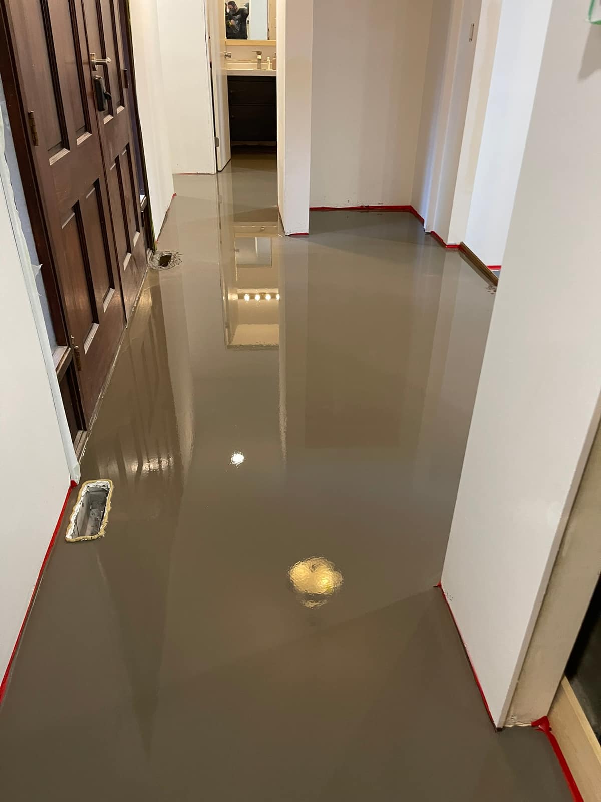 Self-levelling underlayment poured in a Delta home