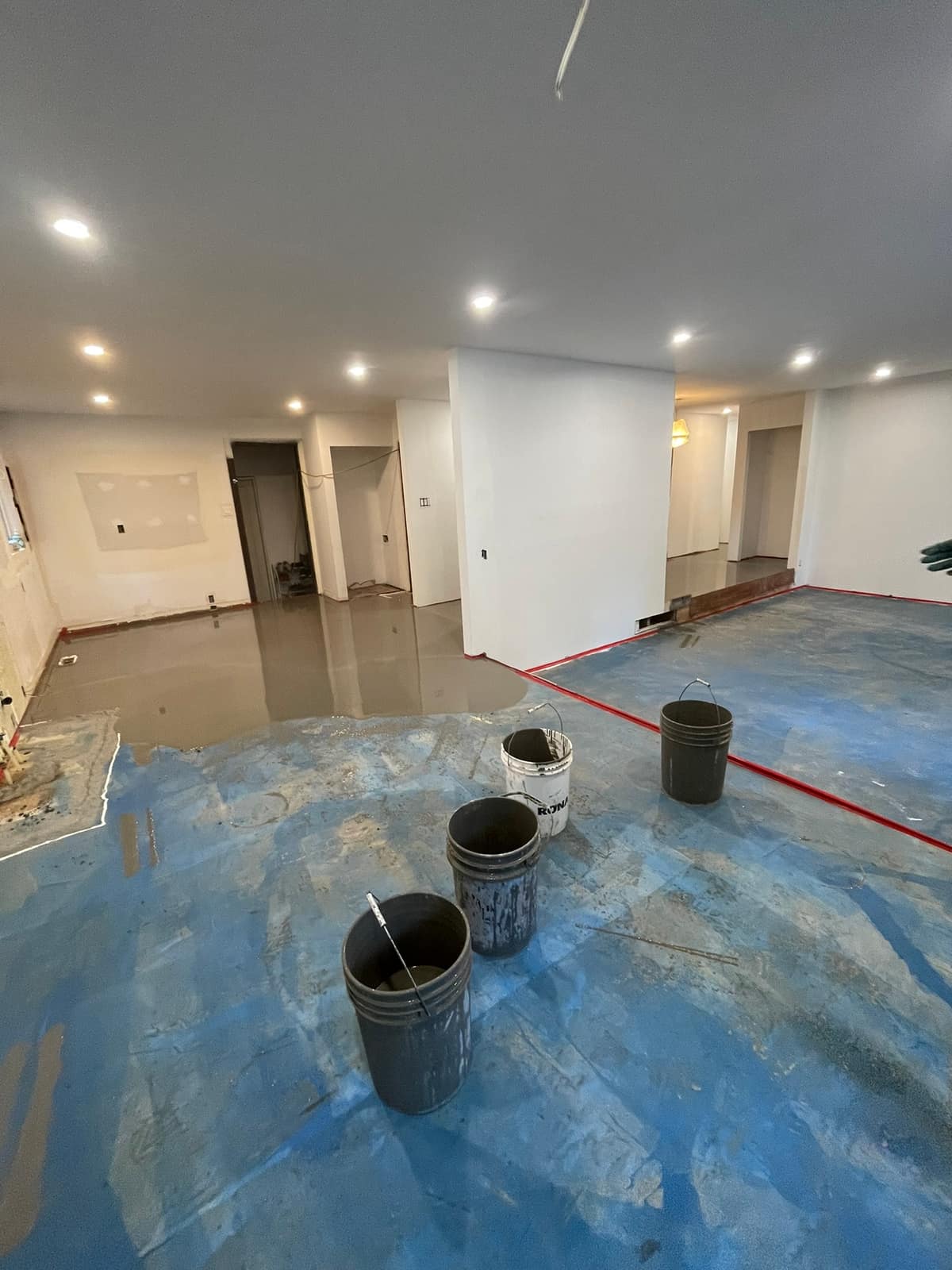 Self-levelling underlayment poured in a Delta home