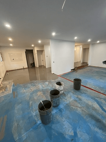 Self-levelling underlayment installation in progress across a Delta home
