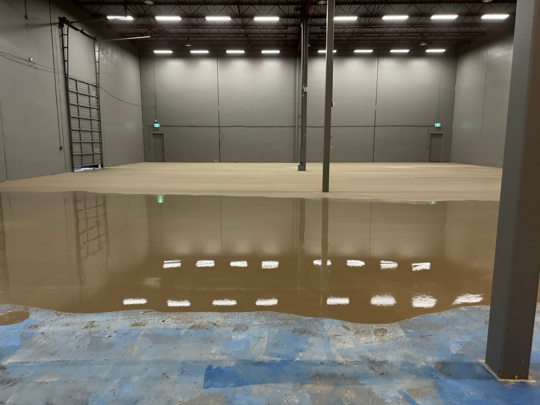 Self-levelling underlayment poured across a Richmond warehouse floor
