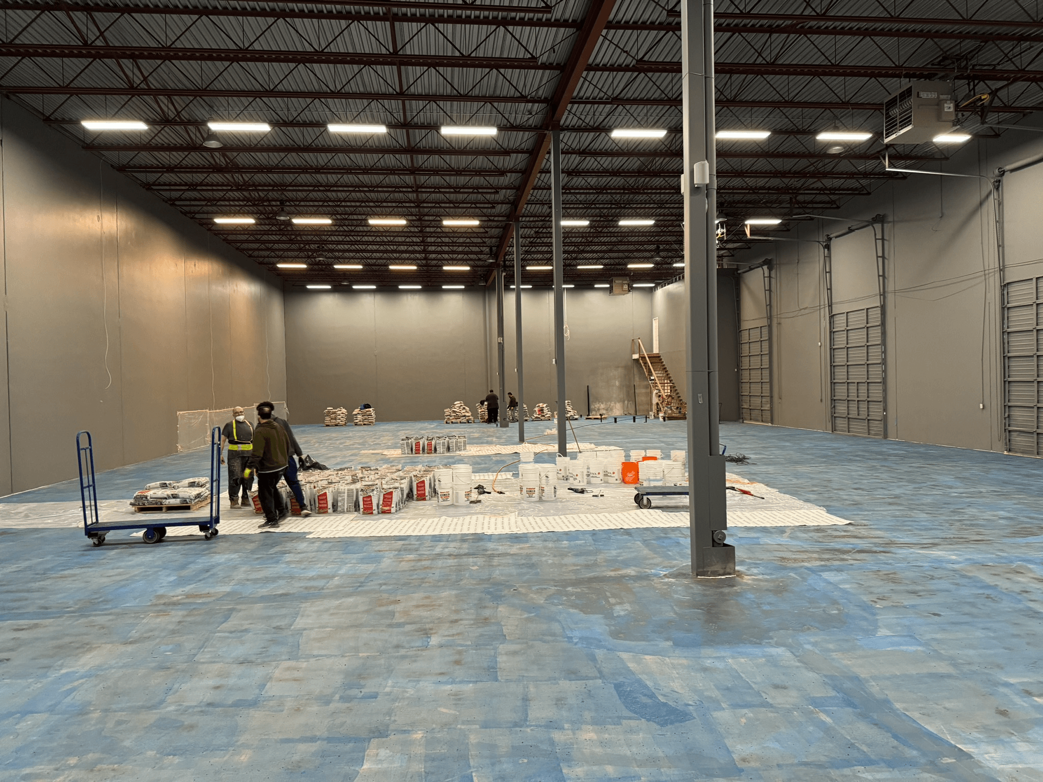 Materials staged for self-levelling work in a Richmond warehouse