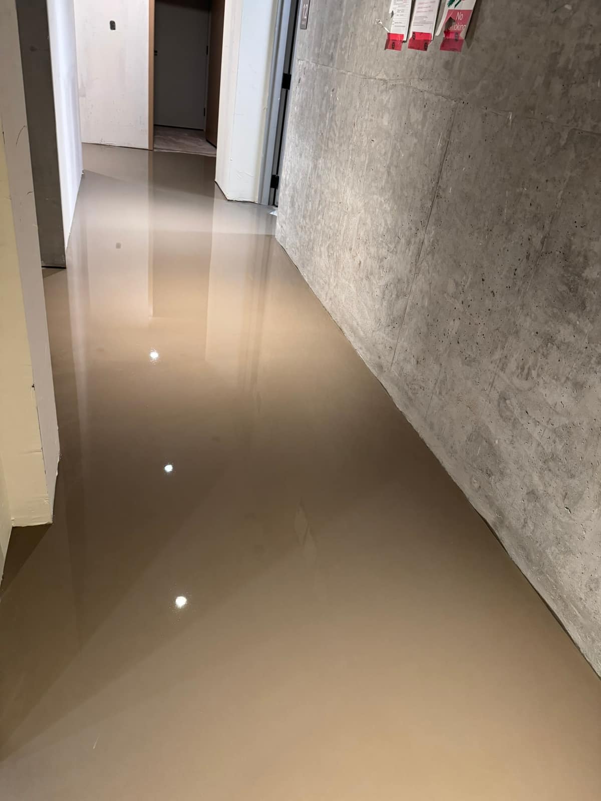 Self-levelling underlayment in a building corridor in Vancouver