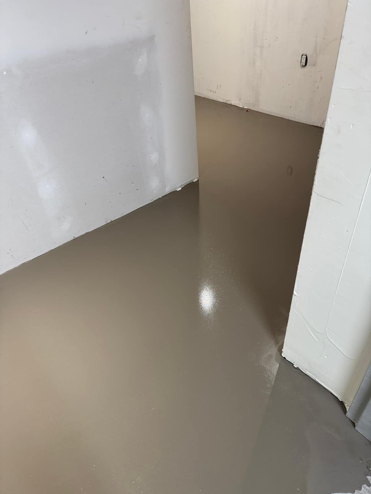Self-levelling underlayment in a building corridor in Vancouver