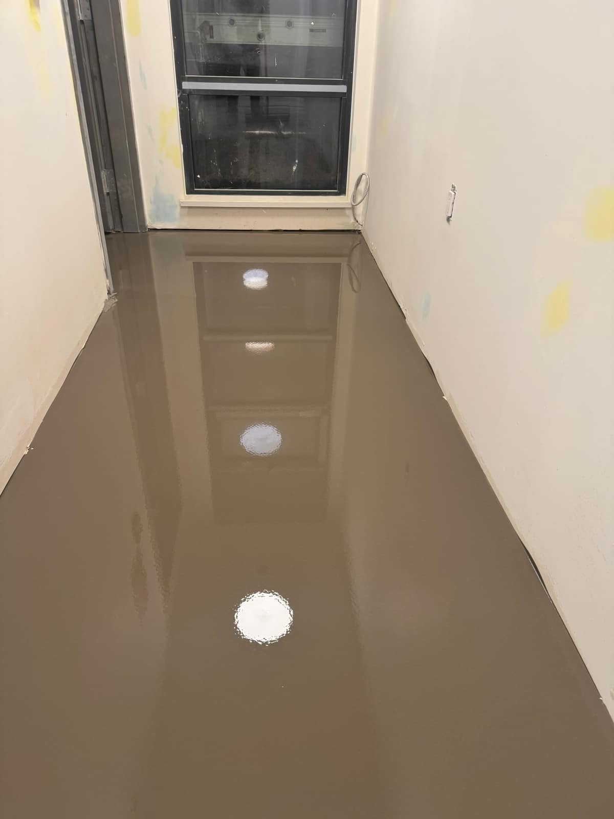 Self-levelling underlayment pour on a Davie Street project in Vancouver