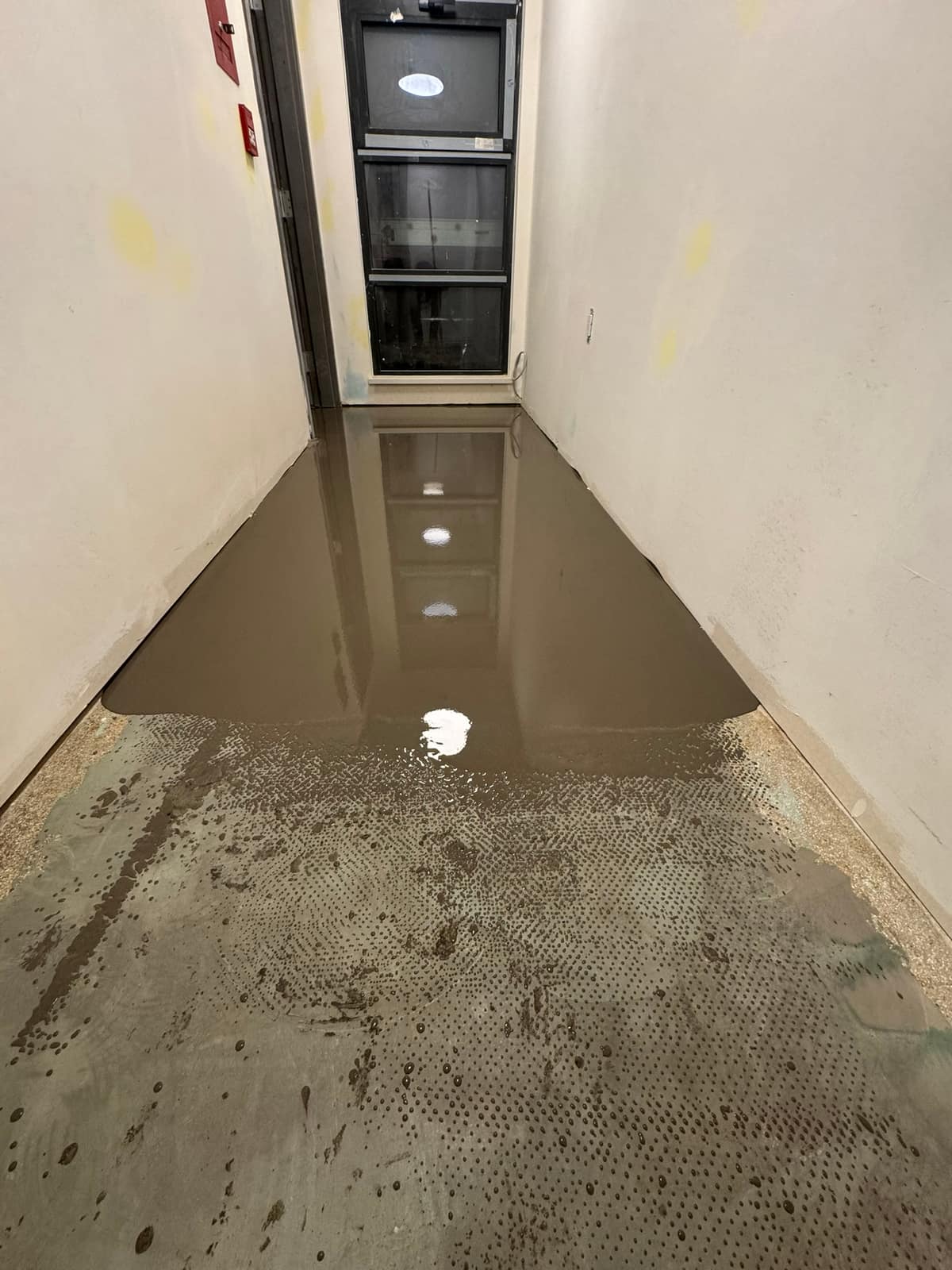 Self-levelling underlayment pour on a Davie Street project in Vancouver