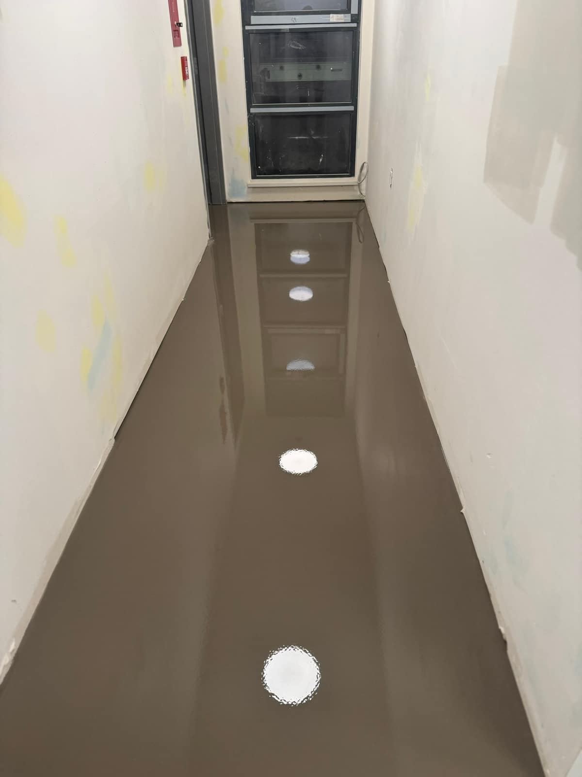 Self-levelling underlayment pour on a Davie Street project in Vancouver