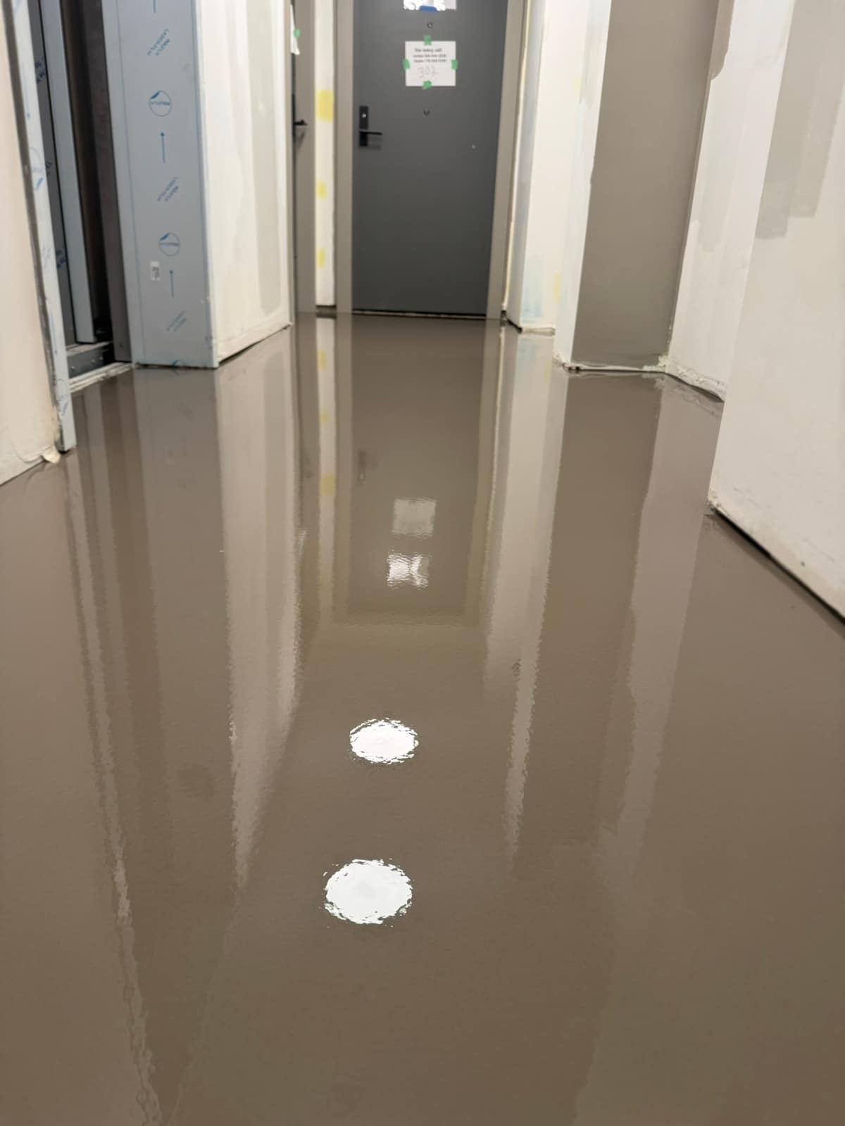 Self-levelling underlayment pour on a Davie Street project in Vancouver