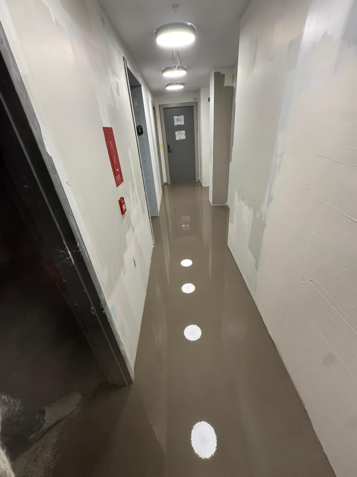 Self-levelling underlayment pour on a Davie Street project in Vancouver