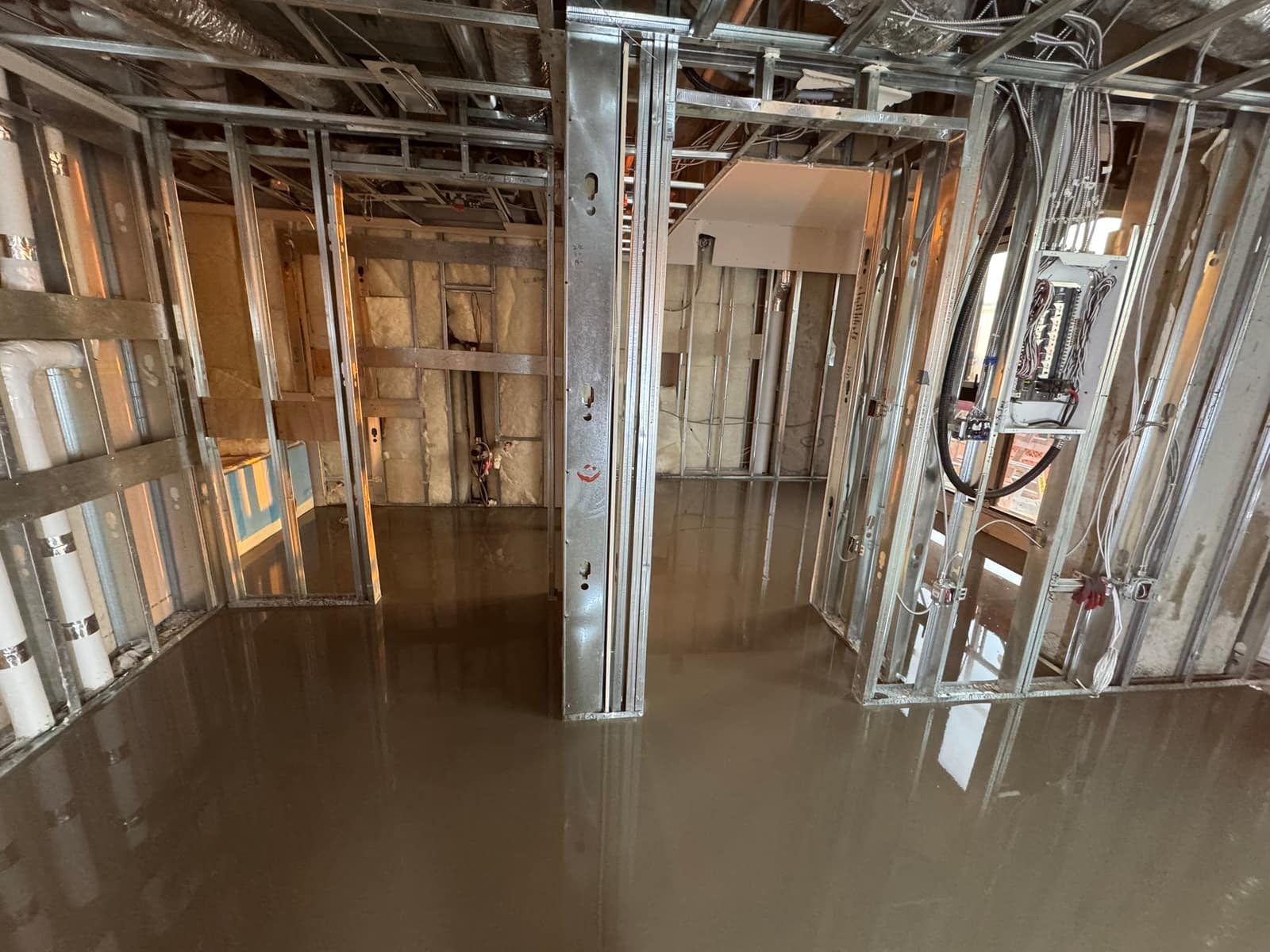 Self-levelling underlayment pour in a West Broadway high-rise in Vancouver